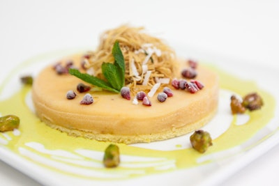 Mango semifreddo on an almond biscuit with coconut kataifi, served with raspberry-studded sweet curry anglaise, by Lyon & Lyon Catering in Miami