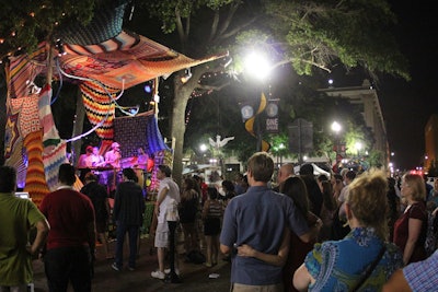 Participants are matched with a venue, which can vary from an office building to a public park. Some bring traditional, trade-show-style booths while others showcase their creativity: last year a musical act crocheted walls and a roof around a stage.