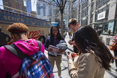 Brand ambassadors distributed customized packets of hot chocolate and crocheted scarves to fans and passersby.