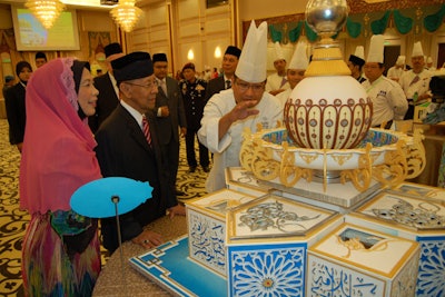 Last year, the Kuala Lumpur Convention Centre presented an enormous cake to His Majesty, the Yang Di-Pertuan Agong Tuanku Abdul Halim Mu'adzam Shah in celebration of the upcoming Hari Raya festival in Malaysia. With the theme of light, the confection included hand-crafted Islamic art motifs inspired by the Islamic Arts Museum Malaysia. The convention center’s pastry team created the four-foot-tall cake that weighed 48 kilograms—or about 106 pounds.