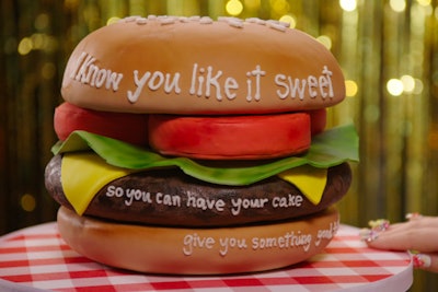 A cake in the shape of a hamburger—lettuce, cheese, tomatoes, and all—included lyrics from Katy Perry's 'Birthday' for the song's video shoot at Duff's Cakemix.