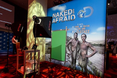 At a green-screen photo setup promoting the new show Naked and Afraid, guests' heads were superimposed on a male or female character from the show (with private parts pixelated). The photos were printed on site.