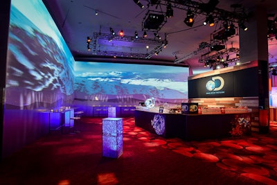 A video wall spanned an entire corner of the reception space, showing images from various networks' programming. Custom highboy tables were decorated with adjectives such as 'style' and 'imagination' that the networks used to describe their content.