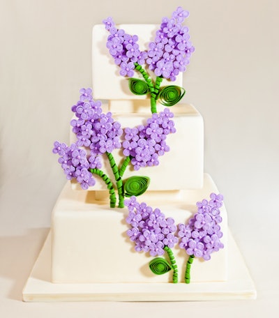 Spring flowers in vibrant purple decked a cake from Chicago's Vanille Patisserie. The baked good got a slightly abstract touch thanks to a modern interpretation of the shape and dimension of petals, leaves, and stems.