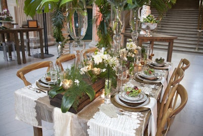 The evening had a showcase of tabletop design. Two Sisters Event Design's reception table was inspired by one of the gowns in the fashion show. The back of the dress had dramatic details that inspired the tropical plant and fern centerpieces.