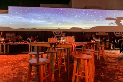 Projection mapping of time-lapse desert scenes illuminated the façade of an adjacent building and was designed to immerse guests in the feeling of the Wild West. The opposite wall included a projection of a waning moon set against a night sky.