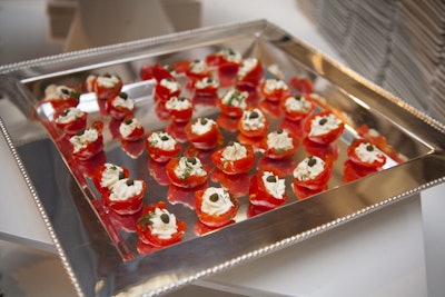 Dainty items, including stuffed cherry peppers with Boursin mousse, were presented on silver trays. Guests ate the snacks in cushy lounge areas decorated by several vendors.