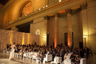 A bridal fashion show featured looks from Francesca Miranda and other designers. Frost lit the room in warm golden and amber hues.