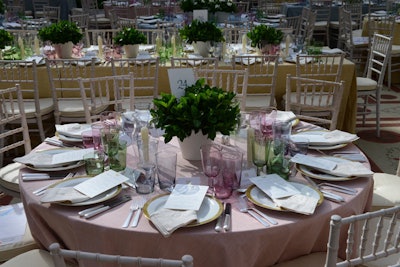 Dinner, served in the Charles Engelhard Court in the American Wing, featured tables covered in pastel cloths in the palette of Charles James's ball gowns developed specifically for the evening using Aerin for Lee Jofa linen fabrics. The imprint of chair Aerin Lauder's lifestyle brand, Aerin, was also evident in the Aerin for Lenox glassware in Goblet, Highball, and Old Fashioned styles in hues of blue, green, and a custom pink. Centerpieces held gardenias—the flower James used to cover a jacket he made for Austine Hearst to wear over the now-iconic Clover Leaf gown.