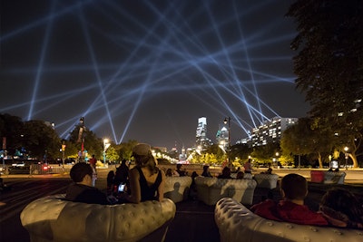 Philadelphia residents relax on Blofield cream colored seating while experiencing Open Air, an interactive artwork event by Rafael Lozano-Hemmer, commissioned by the Association for Public Art.