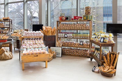 Display areas showcased products like cupcakes and baguettes, and video screens aired content related to the company's history. Though the snacks looked ready to pluck off the tables, food was presented more formally, with servers from Daniel and Daniel passing appetizers. There was also a conveyer belt delivering sliders to the crowd.