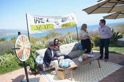 The PTTOW Summit, held in May at Southern California’s Terranea Resort, encouraged conference attendees to sit with one another and answer some of life's big questions. A spinning wheel positioned adjacent to a seating group offered a series of topics—like 'hate,' 'doubt,' and 'purpose'—to break the ice and make the exercise more interesting. The coffee table positioned at the seating group offered a workbook that participants could open to find questions or activities to do together, and the event also offered 'conversation cookies,” fortune cookies filled with more conversation topics. JOWY Productions was behind the event’s production.