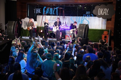 The stage set for the concert was decked with Astroturf, a white picket fence, and a swing set. The setup recalled a playground that's featured in the film.