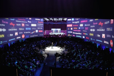 To accommodate the larger guest list and create an immersive concept for the presentation, the producers built a theater-in-the-round, with a relatively small stage in the center. Two curvilinear screens—each 120 feet long and 30 feet tall—hung overheard, offering an almost 360-degree view of the content displayed.