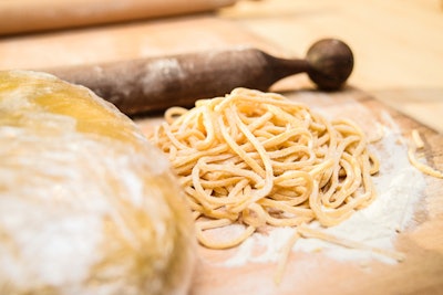 Marc Vetri and Adam Leonti of Vetri in Philadelphia hand made spaghetti alla chitarra, also known as guitar spaghetti. To make it, sheets of pasta are hung over metal wires, which are then 'strummed' in order to cut the pasta into spaghetti strands.