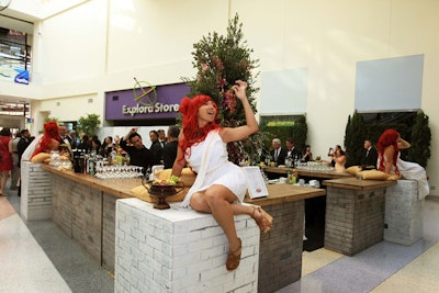 The reception also included the four-sided “Bacchus Bar,” which featured models perched on each corner feeding grapes to guests as they approached.