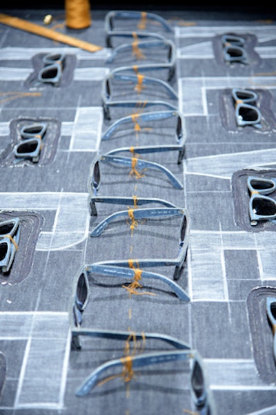 To showcase the denim Wayfarers, Ray-Ban displayed a group of the sunglasses on a sheet of pieced denim that made for instant Instagram fodder. The glasses were tied down with gold string.