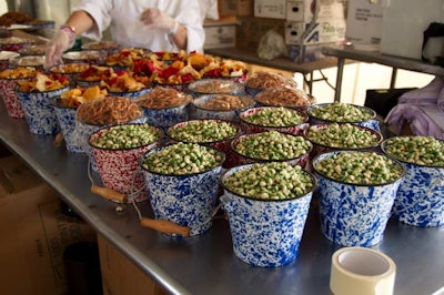 A more casual way to serve snacks is to place them in patterned metal buckets, which is what Eatertainment Special Events and Great Performances did for the 2010 Red Bull Air Race in New York.