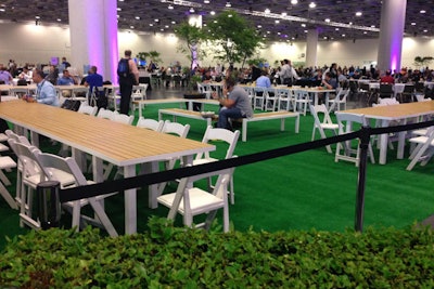 Since the Yerba Buena Gardens could not accommodate everyone at meal time, organizers brought some of the 'parklike feel' inside the Moscone Center meal hall in five zones decorated with Astroturf, picnic tables, and greenery.