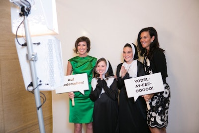 During the cocktail reception, guests could pose in a photo booth with thematic props that included nuns' habits and signs with phrases from the musical. When the photos printed out, they had a backdrop of mountains and blue skies.