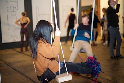 Suspended from the factory ceiling, two swings created playful moments for models and guests.