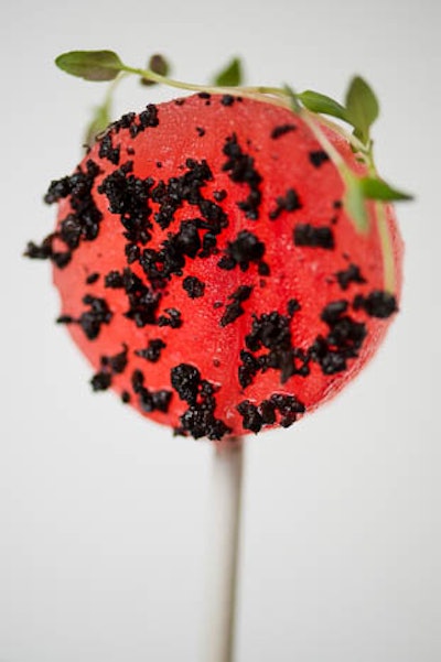 Watermelon lollipops, black olive powder, basil