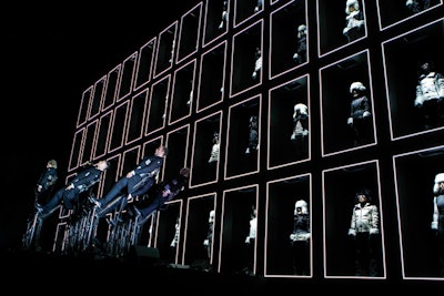 Russo’s production for this year’s Moncler Grenoble show put a choir on hydraulic platforms and 60 models in illuminated boxes.