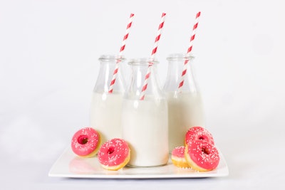 Petite doughnuts and glasses of milk, by Puff ’n Stuff in Orlando