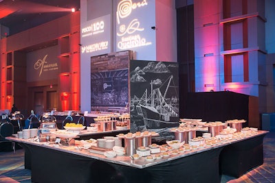 At food stations sponsored by Chile, dishes included ceviche and marinated shrimp with avocado pebre. Coordinating with the food, the chalkboard centerpiece depicted scenes of the country's harbors and fishing boats.