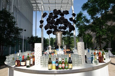 The cocktail reception was held in the museum's Pritzker Garden. HMR Designs, which handled decor for the whole evening, brought in a round central bar with a huge centerpiece of bowler hats.