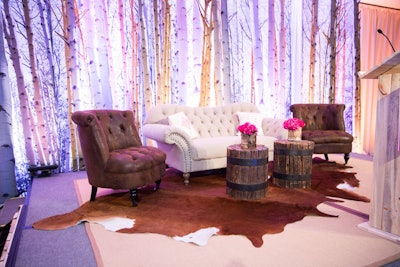 The speaker stage featured a woodsy curtain backdrop, leather seating, and a pop of hot pink flowers.