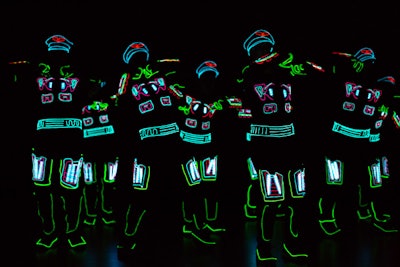Iluminate, an act that has appeared on America's Got Talent, also performed for the crowd. The troupe fuses music, dancing, and technology, and performers wear LED light suits. For the occasion, the dancers sported glowing airline captain's hats.