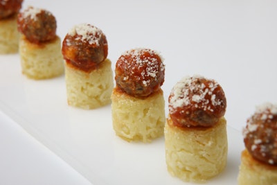 Easy-to-eat mini spaghetti nests, topped with a micro meatball and marinara and sprinkled with Parmesan, by Elegant Affairs in New York