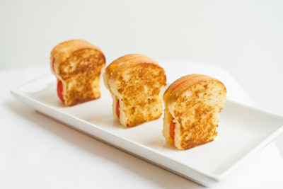 Mini grilled cheese sandwiches with an array of additions, including broccoli, ham, and cherry tomatoes, by L-Eat Catering in Toronto