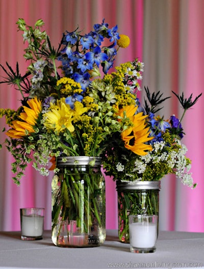 Showorks creates cheerful centerpieces by filling Mason jars of varying sizes with wildflowers, which are reasonably priced per bunch. Repurposed wine and liquor bottles also work as makeshift vases.