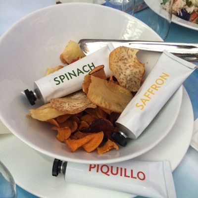 Tables were preset with a dish called 'Landscape.' It contained potato, beet, and kale chips and had spinach, saffron, and piquillo sauces in paint tubes.