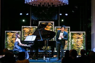 Panels of yellow orchids served as a striking backdrop to the stage in the recital hall.