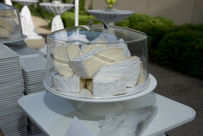 Referencing one of the Magritte works in the current exhibition, which features a painting of brie cheese on a domed glass plate, the cocktail-hour buffet held large chunks of the creamy cheese.