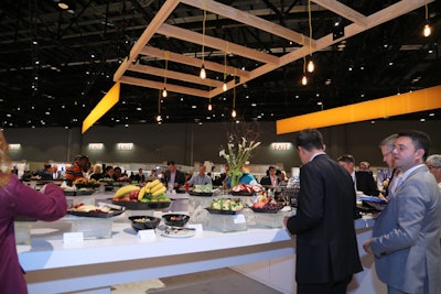 Lighting hung from wood beams above the food counters in the executive meeting center to keep the design consistent with the wood pallets used in the new networking area.