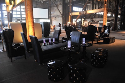Sleek black lounge furniture provided a comfortable place to kick back in the raw venue.