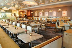 Buzzed-about restaurant Travelle opened in the Langham Chicago hotel last August with spots for entertaining groups of varying sizes. Designed by the Rockwell Group, the 125-seat restaurant has an 81-seat bar. The beverage program was inspired by the corporate culture of the 1960s and includes mobile bar carts, allowing servers to prepare martinis and Manhattans table-side. Seating combines custom and mid-century pieces, and the focal point is a backlit wall with a 30-foot digital art display. A wine room with a tasting area and Chicago River views can host wine tastings for 10. A chef's table next to the expo kitchen seats eight. Chef Tim Graham, a veteran of Tru, serves Mediterranean-inspired fare including flaming chicken saganaki with pita 'balloons' and the 'Seafood Elevation,' which offers bowls of shrimp, oysters, lobster, and King crab in separate bowls on a custom stand.