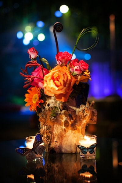 Similar to branches, stumps are creative replacements for expensive vessels and leave more funds for flowers. Showorks dresses up the humble tree trunk with vibrant roses and gerbera daises.