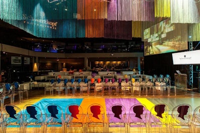 The Schwarzkopf hair show in Los Angeles last year had a color-blocked look marked by bright, tropical shades. A canopy of colorful fringe hung over the event space, and ghost chairs were emblazoned with versions of the beauty brand's logo.
