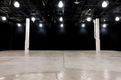 Ground view of main event floor, black drapes