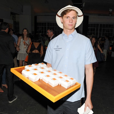 Catered by Laurence Craig Catering, miniature sirloin sliders in potato buns were among the bite-size foods served during the event. In keeping with the event theme, each box bore a custom Veuve Clicquot postage stamp.