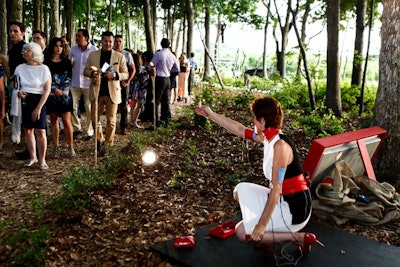 This year's walk through the center's forest featured more than two dozen live art installations, including Francesca Fini's 'Fair and Lost.' The artist and performer attempted to apply makeup while her arms are repeatedly jolted with electric shocks.