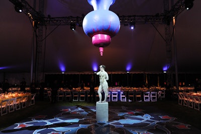 Influenced by a lamp commissioned by the Shah of Iran for the embassy in Washington, D.C., Parnes enlarged a copy of the item to hang as the centerpiece of the dinner tent. Titled 'Kărvăn,' made of composite material, and measuring 8 by 6 feet, it required seven people to hoist. The dance floor's design was based on a traditional singular Persian tile blown up to play off the loud and pop-color theme of the dinner area. Performing for guests as they entered was Brittany's Bailey's 'A Dance, or Two.'