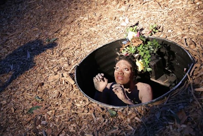 While the gala has featured plenty of installations where artists/models lay on the ground, this year Joelle Beli Titi took it one step further with 'The Survival: How to Penetrate the Darkness.' The artist and performer stood within a nearly six-foot-deep hole, wearing a flowered headpiece while operatically singing.