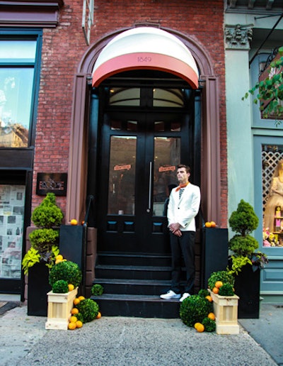 The Broome Hotel entrance was reimagined with topiaries and orange fruit accents. A custom awning was also built for the occasion, along with a model greeter staged out front to welcome guests.