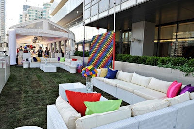 In one area, guests lounged in white sofas strewn with brightly colored pillows. Flower arrangements had fitting rainbow hues.